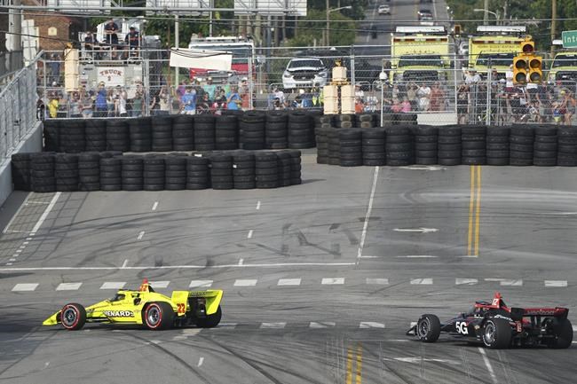 CORRECTS TO TURN 9 NOT TURN 1 - Simon Pagenaud (22) leads Will Power (12) into Turn 9 during the IndyCar Music City Grand Prix auto race Sunday, Aug. 8, 2021, in Nashville, Tenn. (AP Photo/Harrison McClary)