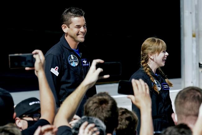 Jared Isaacman, left, and Hayley Arceneaux prepare to head to launchpad 39A for a launch on a SpaceX Falcon 9 at the Kennedy Space Center in Cape Canaveral, Fla., Wednesday Sept. 15, 2021. (AP Photo/John Raoux)
