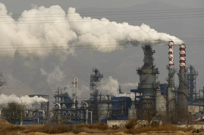 FILE - In this Nov. 28, 2019, file photo, smoke and steam rise from a coal processing plant in Hejin in central China's Shanxi Province. Global shoppers face possible shortages of smartphones and other goods ahead of Christmas after power cuts to meet government energy use targets forced Chinese factories to shut down and left some households in the dark. (AP Photo/Olivia Zhang, File)