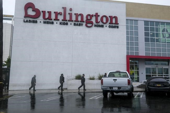 Police officers arrive the scene where two people were struck by gunfire in a shooting at the Burlington Coat Factory store in North Hollywood, Calif., Thursday, Dec. 23, 2021. (AP Photo/Ringo H.W. Chiu)