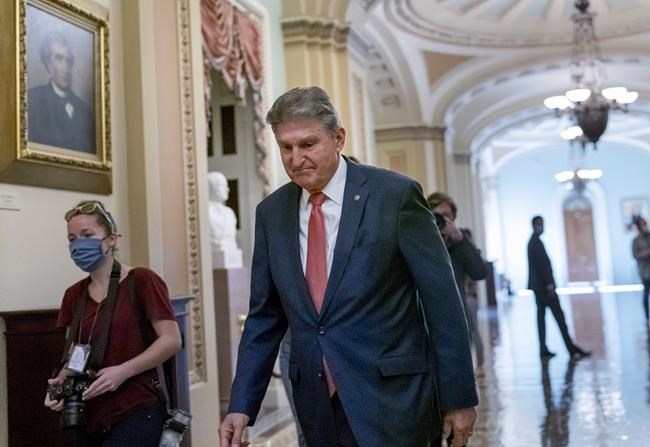 Sen. Joe Manchin, D-W.Va., a centrist Democrat vital to the fate of President Joe Biden's legislative agenda, walks to a caucus lunch at the Capitol in Washington, Friday, Dec. 17, 2021. Despite months of being courted and cajoled, Manchin says he will not support Biden's Build Back Better bill. THE CANADIAN PRESS/AP, J. Scott Applewhite