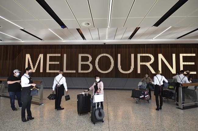 Passengers arrive at Melbourne Airport in Melbourne, Monday, Feb. 21, 2022. International tourists and business travelers began arriving in Australia with few restrictions for the first time in almost two years after the government lifted some of the most draconian pandemic measures of any democracy in the world. (Joel Carrett/AAP Image via AP)