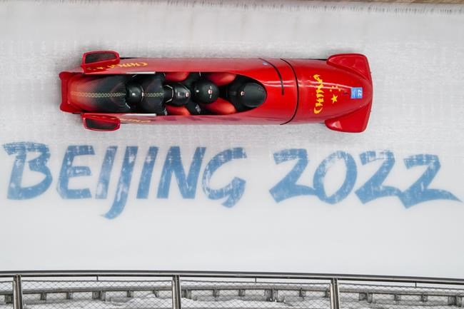 Li Chunjian, Ding Song, Ye Jielong and She Hao, of China, slide during the 4-man heat 1 at the 2022 Winter Olympics, Saturday, Feb. 19, 2022, in the Yanqing district of Beijing. (AP Photo/Pavel Golovkin)