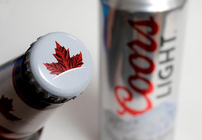 Molson Coors Beverage Co. has raised it dividend amid higher sales and profits in its latest quarter as the company benefited from the reopening of venues and an increase in premium beverages sales. Molson Canadian and Coors Light beer are shown in this Nov. 28, 2018 file photo. THE CANADIAN PRESS/AP-Steven Senne