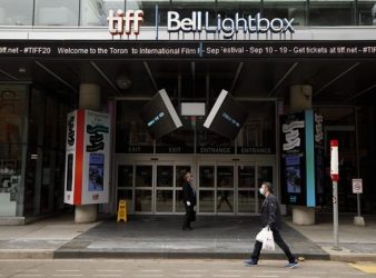 A person walks passed Toronto International Film Festival's TIFF Bell Lightbox theatre on King St., in Toronto, Thursday, Sept. 10, 2020. The Toronto International Film Festival and Hot Docs are offering free perks to welcome young audiences back to the theatre.THE CANADIAN PRESS/Cole Burston