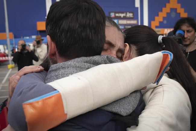 Relatives hug each other after arriving from the Ukrainian city of Mariupol at a center for displaced people in Zaporizhzhia, Ukraine, Tuesday, May 3, 2022. (AP Photo/Evgeniy Maloletka)