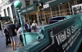 FILE - People walk on Broadway at Wall Street, Wednesday, June 16, 2021. Stocks are opening lower on Wall Street, Wednesday, May 18, 2022, led by steep drops in retailers as Target plunged after issuing a grim quarterly earnings report.AP Photo/Richard Drew, File)