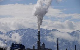 The Utah State Capitol, rear, is shown behind an oil refinery on Thursday, May 12, 2022, in Salt Lake City. A growing number of Republican-led states with economies that rely heavily on fossil fuels are pushing back against shifts in the financial industry to consider new factors such as environmental risk in their investment decisions. (AP Photo/Rick Bowmer)