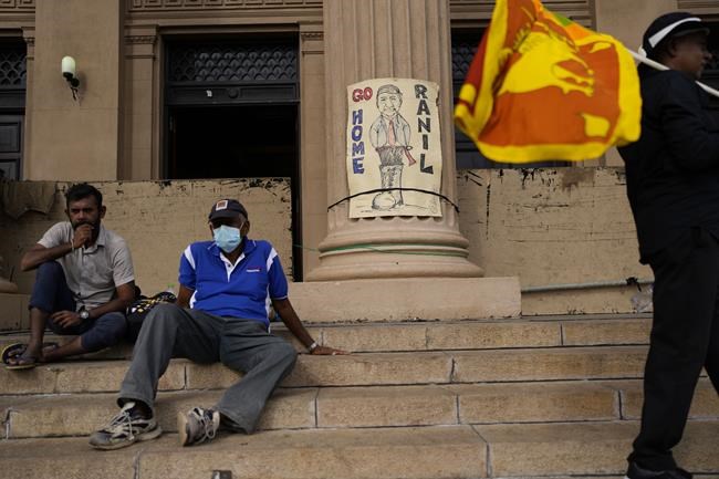 Protesters rest as they join the demand that elected president Ranil Wickremesinghe step down in Colombo, Sri Lanka, Wednesday, July 20, 2022. Sri Lanka's prime minister was elected president Wednesday by lawmakers who opted for a seasoned, veteran leader to lead the country out of economic collapse, despite widespread public opposition.(AP Photo/Rafiq Maqbool)